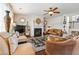 Cozy living room with fireplace, ceiling fan, neutral paint, and comfortable seating at 3613 Lake Estates Way, Atlanta, GA 30349