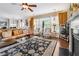 Bright living room featuring fireplace, ceiling fan, large windows, and hardwood floors at 3613 Lake Estates Way, Atlanta, GA 30349