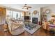 Comfortable living room with a fireplace, plush seating, and large windows with draperies at 3613 Lake Estates Way, Atlanta, GA 30349