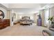 An expansive and inviting main bedroom features a tray ceiling, large windows, and plush carpeting at 3613 Lake Estates Way, Atlanta, GA 30349