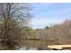 Scenic view of a tranquil pond surrounded by trees, offering a peaceful natural setting at 3613 Lake Estates Way, Atlanta, GA 30349