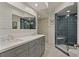 Modern bathroom with double sink vanity, large mirror and a glass-enclosed shower with stylish tile at 3636 Habersham Nw Rd # 2103, Atlanta, GA 30305