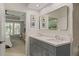 Bathroom boasts a double vanity with a large mirror, with a glimpse into the bedroom at 3636 Habersham Nw Rd # 2103, Atlanta, GA 30305