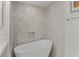 Bright bathroom with a freestanding tub, elegant marble-like tile and a recessed shelf at 3636 Habersham Nw Rd # 2103, Atlanta, GA 30305