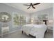 Cozy bedroom featuring a queen-size bed, decorative mirror, and natural light from the windows at 3636 Habersham Nw Rd # 2103, Atlanta, GA 30305