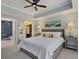 Large bedroom featuring a tray ceiling, large windows, and an open entrance to the bathroom at 3636 Habersham Nw Rd # 2103, Atlanta, GA 30305