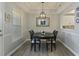 Elegant dining room with a modern light fixture and a view into the kitchen at 3636 Habersham Nw Rd # 2103, Atlanta, GA 30305