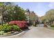 Charming entrance to a residential community with lush landscaping and gated access at 3636 Habersham Nw Rd # 2103, Atlanta, GA 30305