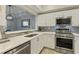 Modern kitchen with white cabinets, stainless steel appliances, and quartz countertops at 3636 Habersham Nw Rd # 2103, Atlanta, GA 30305