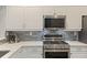 Modern kitchen featuring white cabinets, stainless steel appliances, and granite countertops at 3636 Habersham Nw Rd # 2103, Atlanta, GA 30305