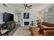 Comfortable living room with a fireplace, television, and lots of natural light at 3636 Habersham Nw Rd # 2103, Atlanta, GA 30305