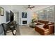 Cozy living room with a fireplace, large brown sectional, and lots of natural light at 3636 Habersham Nw Rd # 2103, Atlanta, GA 30305
