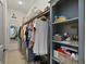 Spacious walk-in closet features custom shelving and ample storage for clothing and accessories at 3636 Habersham Nw Rd # 2103, Atlanta, GA 30305