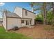 View of backyard features a well-maintained lawn and rear exterior of the home at 6244 Marbut Farms Trl, Lithonia, GA 30058