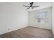 Bright bedroom with ceiling fan, neutral walls, and wood-look flooring at 6244 Marbut Farms Trl, Lithonia, GA 30058