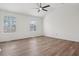 Bright bedroom features large windows, ceiling fan and wood flooring at 6244 Marbut Farms Trl, Lithonia, GA 30058