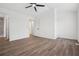 The bright bedroom features durable wood flooring, ceiling fan and access to the ensuite bathroom at 6244 Marbut Farms Trl, Lithonia, GA 30058