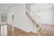 Bright entryway with hardwood floors and white staircase with banister at 6244 Marbut Farms Trl, Lithonia, GA 30058