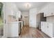 Modern kitchen with white cabinets, stainless steel appliances, and stylish backsplash at 6244 Marbut Farms Trl, Lithonia, GA 30058