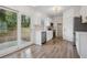 Modern kitchen with white cabinets, stainless steel appliances, and sliding door to the backyard at 6244 Marbut Farms Trl, Lithonia, GA 30058
