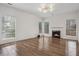 Spacious living room with hardwood floors, a fireplace, and plenty of natural light from many windows at 6244 Marbut Farms Trl, Lithonia, GA 30058
