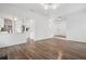 Open concept living room with hardwood floors, staircase, and pass-through to the kitchen at 6244 Marbut Farms Trl, Lithonia, GA 30058