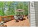 Outdoor wooden deck with dining table and chairs, perfect for outdoor entertaining at 955 Bishopswood Pl, Johns Creek, GA 30022