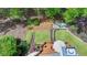 Aerial view of outdoor living space featuring a deck, fire pit, and landscaped gardens at 955 Bishopswood Pl, Johns Creek, GA 30022