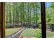 Beautiful wooded backyard features a stone pathway leading to a seating area at 955 Bishopswood Pl, Johns Creek, GA 30022