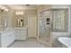 Stylish bathroom with a glass shower, marble countertops, and modern fixtures at 955 Bishopswood Pl, Johns Creek, GA 30022