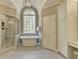 Bright bathroom featuring a standalone tub, glass shower, and marble accents at 955 Bishopswood Pl, Johns Creek, GA 30022