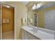 Well-lit bathroom with a wide vanity, large mirror, and warm yellow wall color at 955 Bishopswood Pl, Johns Creek, GA 30022