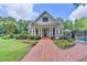 Charming community clubhouse with a brick walkway, manicured garden, and covered entrance at 955 Bishopswood Pl, Johns Creek, GA 30022