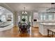 Open-concept dining area flowing into a cozy living space with lots of natural light at 955 Bishopswood Pl, Johns Creek, GA 30022