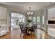 Dining area open to the living room featuring hardwood floors and a view of the outdoors at 955 Bishopswood Pl, Johns Creek, GA 30022