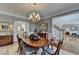 Elegant dining room featuring a decorative chandelier, hardwood floors and classic mouldings at 955 Bishopswood Pl, Johns Creek, GA 30022
