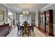 Formal dining room with beautiful windows, crown molding, and hardwood flooring at 955 Bishopswood Pl, Johns Creek, GA 30022