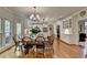 Bright dining room with wood floors and lots of natural light, adjacent to the kitchen at 955 Bishopswood Pl, Johns Creek, GA 30022