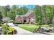 Charming brick home featuring a well-manicured front lawn and mature landscaping at 955 Bishopswood Pl, Johns Creek, GA 30022