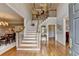 Elegant foyer showcasing a grand staircase and gleaming hardwood floors at 955 Bishopswood Pl, Johns Creek, GA 30022