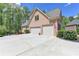 Brick home with a three car garage and a spacious driveway at 955 Bishopswood Pl, Johns Creek, GA 30022