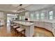 Open concept kitchen with a central island, counter seating and lots of natural light at 955 Bishopswood Pl, Johns Creek, GA 30022