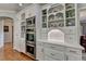 Custom kitchen cabinetry and storage featuring display shelves, built in oven and modern appliances at 955 Bishopswood Pl, Johns Creek, GA 30022