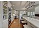 Kitchen area featuring long island with seating, adjacent to built in pantry and serving area at 955 Bishopswood Pl, Johns Creek, GA 30022