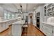 Modern white kitchen with a large island, updated appliances, and hardwood floors at 955 Bishopswood Pl, Johns Creek, GA 30022