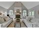 Inviting living room with high ceilings, a brick fireplace, and large windows to outside deck at 955 Bishopswood Pl, Johns Creek, GA 30022
