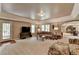 Spacious living room features plush carpet, tray ceiling, and a view of the backyard at 955 Bishopswood Pl, Johns Creek, GA 30022