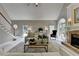 Bright living room boasts neutral decor, staircase, fireplace, and large windows at 955 Bishopswood Pl, Johns Creek, GA 30022