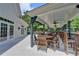 Covered outdoor lounge area with ceiling fans and dining sets for neighborhood socializing at 955 Bishopswood Pl, Johns Creek, GA 30022