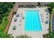 A relaxing community pool with lounge seating and umbrellas, surrounded by lush greenery and mature trees at 955 Bishopswood Pl, Johns Creek, GA 30022